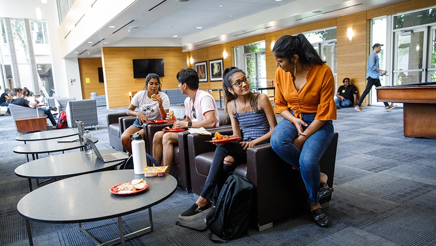 Several students engaging in conversation at the Barrett Tempe Honors Hall Social Lounge
