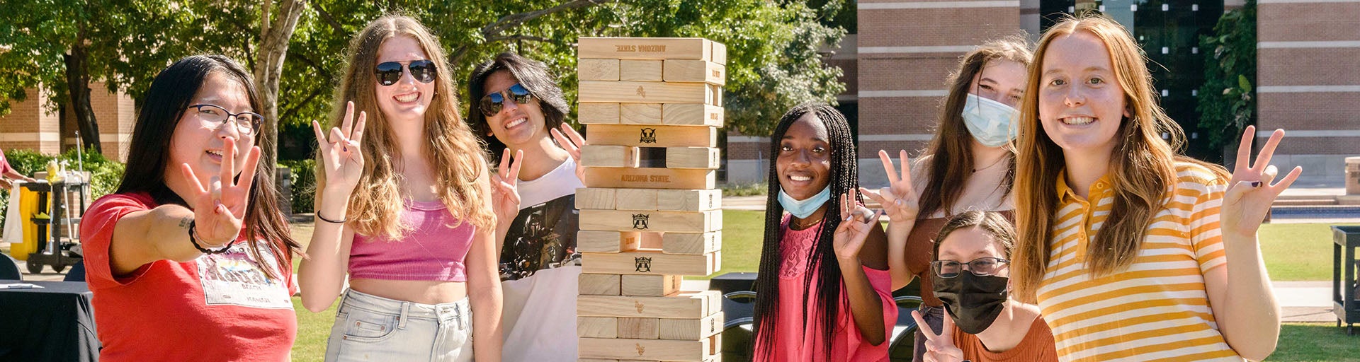 Seven Barrett students playing games outside at the Barrett West campus