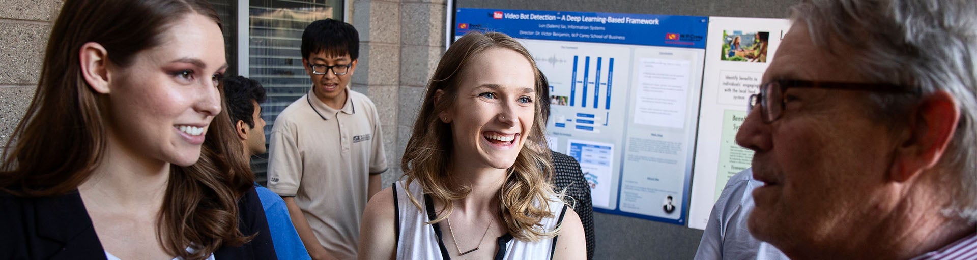 Several students having a discussion about their thesis