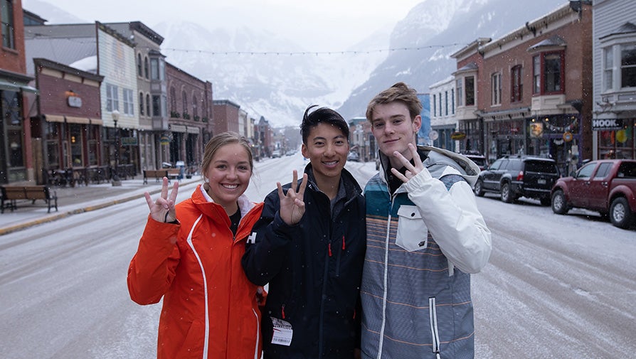 Three Barrett students showing the pitchfork sign in the snow at Telluride, Colorado