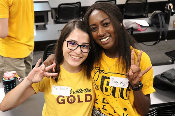 Two Barrett students wearing ASU gold attire