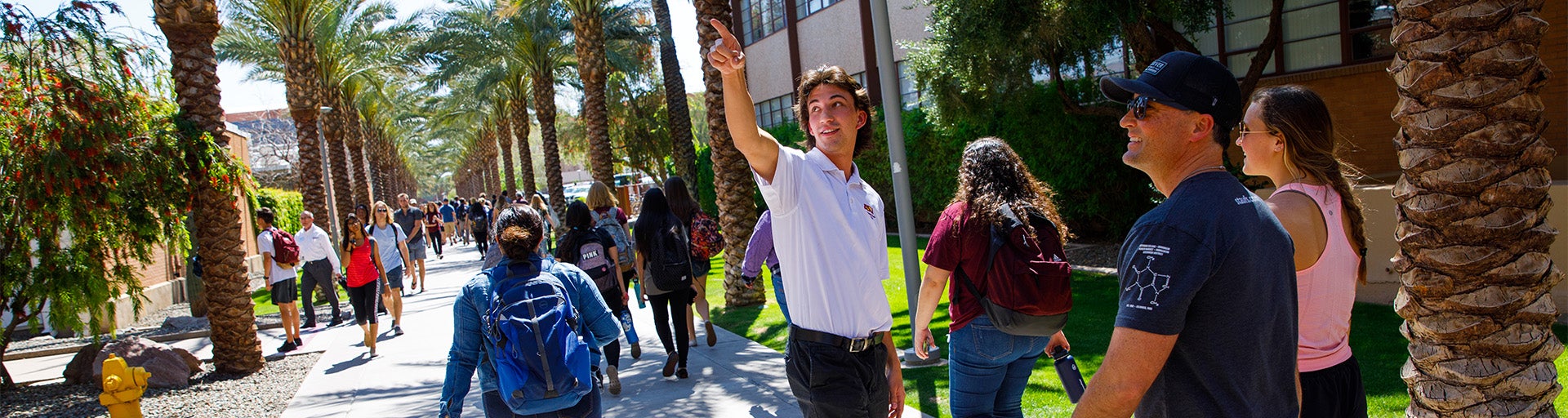 ASU tour guide showing prospective students and family members around campus