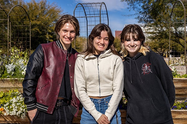 Three Barrett students at Poly campus exterior