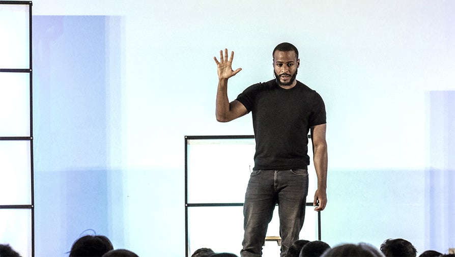 Man speaking to a room full of people