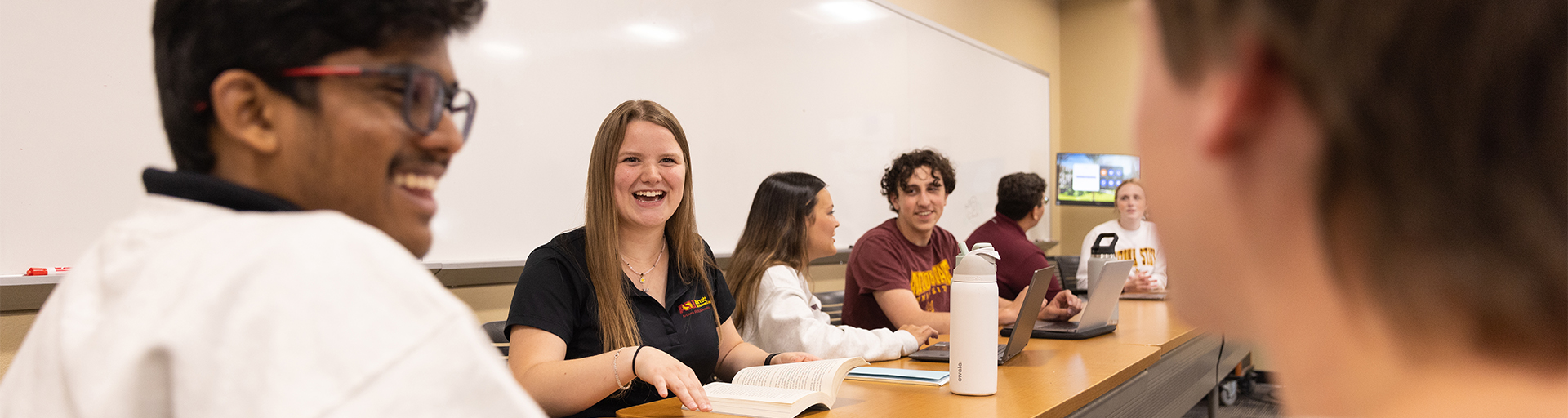 Small group of Barrett students having a conversation in a classroom
